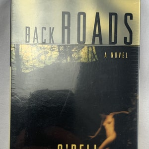 May include: A black and white book cover with the title "Back Roads" in large, white letters. The author's name, "Tawni O'Dell", is in yellow letters below the title. The cover features a blurry image of a person in a forest setting. The text "A Novel" is in white letters below the author's name.