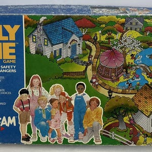 May include: A vintage "Safely Home" board game box. The box is blue with the game title in large orange letters. The game's theme is personal safety and saying "no" to strangers. The box art features children and a colorful neighborhood scene.