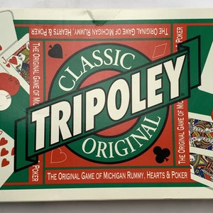 May include: A green, red, and white box for the Classic Tripoley Original game. The box features the game's name in a large, bold font and includes the text "The Original Game of Michigan Rummy, Hearts & Poker".