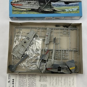 May include: Model kit of a Gotha Go-242/244 aircraft. The box art shows a detailed illustration of the plane in flight. Inside, the kit includes unassembled plastic parts and instructions. Scale 1:72.