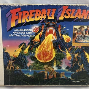 May include: Vintage Fireball Island board game box. The box features a vibrant illustration of a volcanic island with a fiery eruption. The game is for 2 to 4 players, ages 7 and up. The box has the Milton Bradley Company logo.