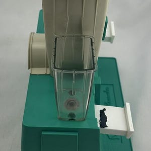 May include: A white ceramic mug with a black handle and the text "But First, Coffee" in a black, bold font. The mug is on a white surface.