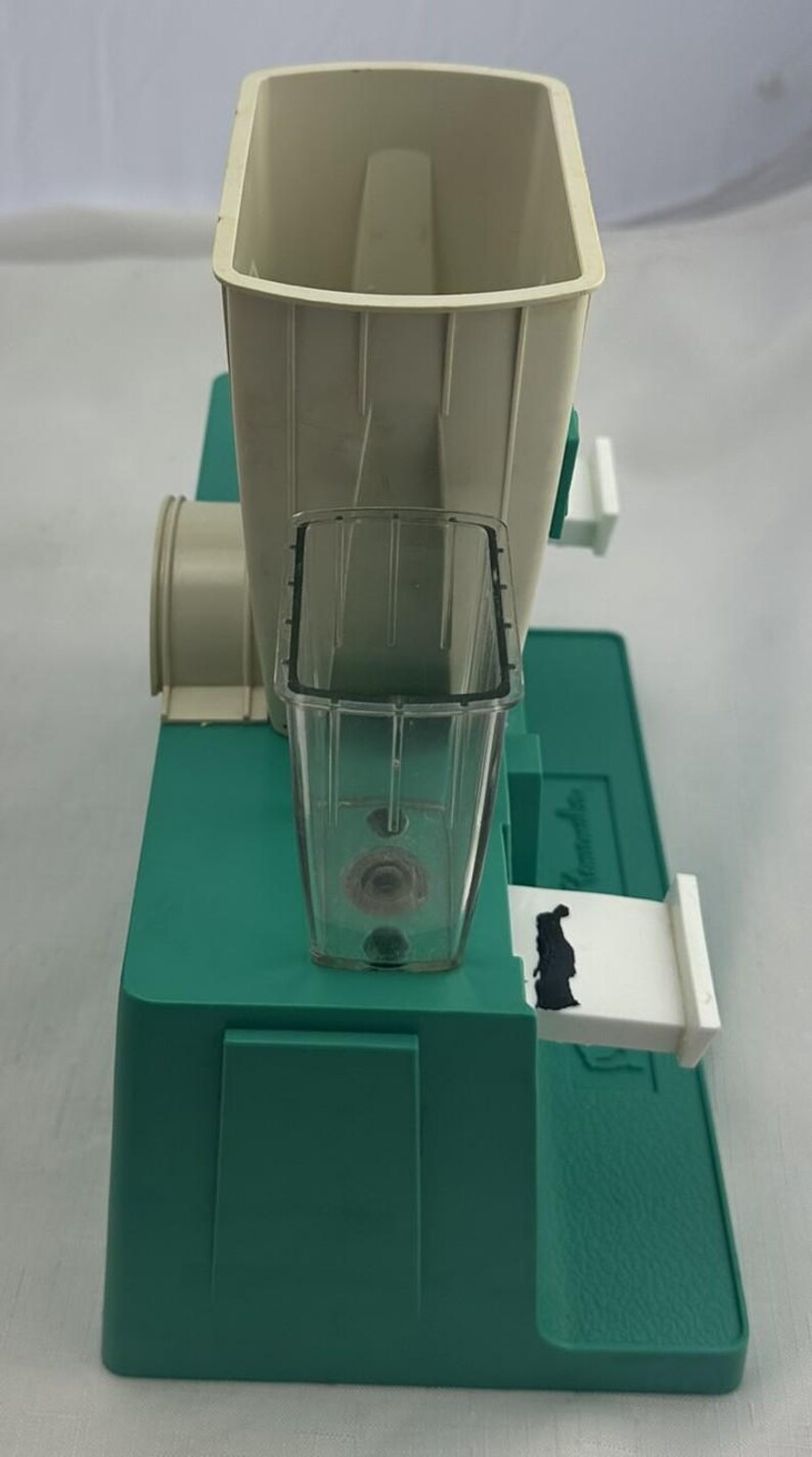 May include: A white ceramic mug with a black handle and the text "But First, Coffee" in a black, bold font. The mug is on a white surface.