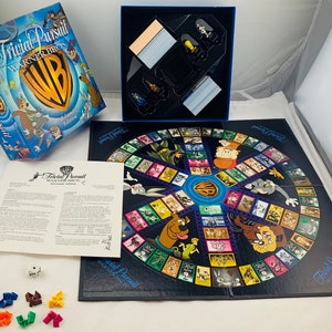 May include: Trivial Pursuit Warner Bros. Edition board game. The box features Warner Bros. characters and the WB logo. The game board is circular with cartoon images. Includes game pieces, dice, and instructions.