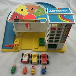 May include: A vintage Fisher-Price Little People Garage playset. The playset features a multi-colored ramp, a garage with a rainbow design, and a rotating dial. Includes three toy cars and four Little People figures.