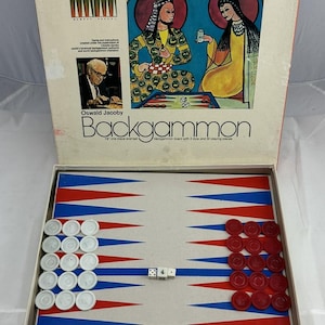 May include: Vintage Backgammon game set by Pressman, featuring a game board with red, white, and blue triangles. The box lid displays artwork of two figures and the text "Backgammon" and "Oswald Jacoby". Includes dice and playing pieces.