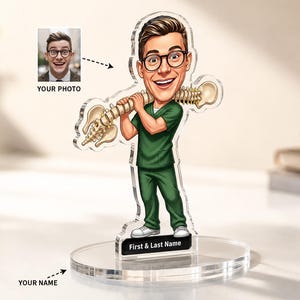 May include: A custom acrylic standee featuring a cartoon illustration of a person wearing green medical scrubs and glasses, holding a human spine over their shoulders. The base includes a black rectangular plaque labeled First & Last Name.