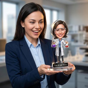May include: A custom acrylic bobblehead figure depicting a scientist wearing a white lab coat and safety goggles, holding a purple flask in one hand and a red flask in the other. The base features a black plaque with the text First & Last Name.