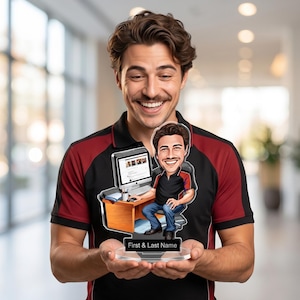May include: A custom acrylic desk ornament featuring a cartoon caricature of a person sitting at a wooden desk with a computer monitor, keyboard, and mouse. The base of the clear acrylic stand includes a black rectangular nameplate with the text First & Last Name.