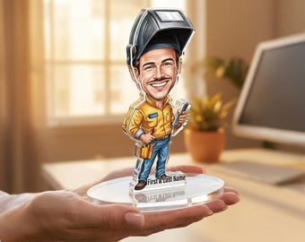 May include: A cartoon-style acrylic figure of a smiling welder wearing a welding helmet and holding tools. The figure is dressed in a yellow shirt and blue jeans, standing on a clear, round base with the text "First & Last Name".
