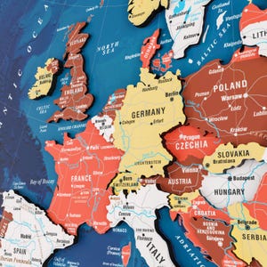 May include: A detailed, colourful map of Europe, showing countries with borders and major cities. The map has a three-dimensional design, with each country raised. The North Sea and Baltic Sea are also labelled.
