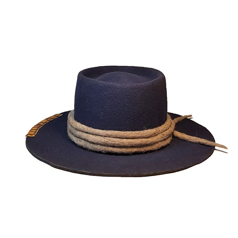 May include: A navy blue felt fedora hat with a wide brim and a brown braided band around the crown.