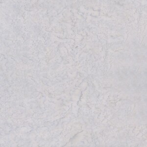 May include: A close-up of a white textured surface with a subtle pattern of light gray lines.