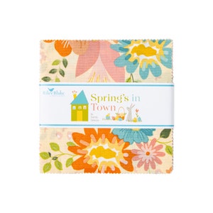 May include: A fabric square with a floral pattern in shades of pink, orange, yellow, and blue. The fabric features a house with a chimney and a bunny rabbit holding an Easter basket. The text "Spring's in Town" is printed on the fabric.