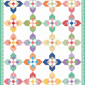 May include: A quilt with a white background and 20 colorful squares arranged in a grid pattern. Each square features a diamond shape in the center with a white background and a colorful border. The quilt is made with a variety of floral and geometric patterns.