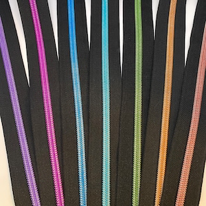 Zipper "Intense Colors", black, wide / Continuous zipper with metallized plastic bead / Sold by the meter