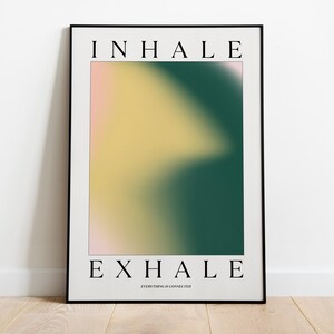 May include: A framed art print with the words "INHALE" and "EXHALE" in black, centered at the top and bottom. The artwork features a blurred gradient of colors, including yellow, green, and pink. The text "EVERYTHING IS CONNECTED" is below "EXHALE".