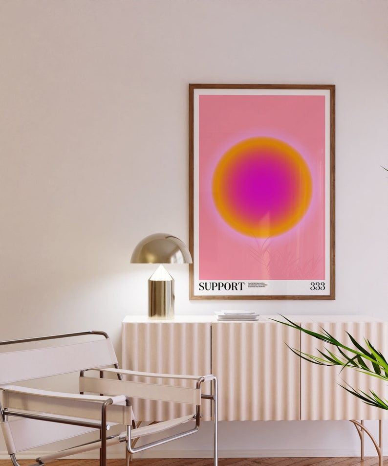May include: A framed print with a pink background and a large, gradient circle in the center. The circle transitions from yellow to orange to pink. The text "SUPPORT" is printed below the circle, along with a small number.