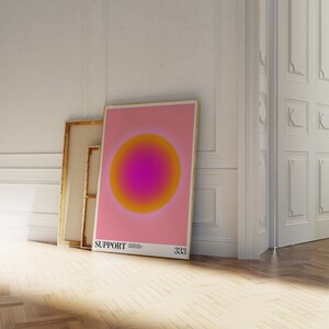 May include: A pink poster with a large, yellow and pink gradient circle in the center. The poster has the text "SUPPORT" and "333" at the bottom.