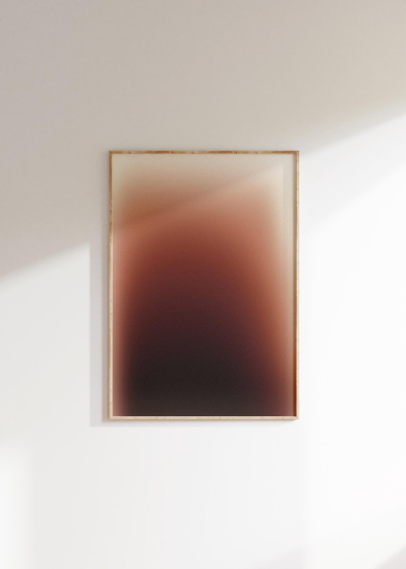May include: A framed art print featuring a colour gradient. The artwork fades from a light beige at the top to a dark burgundy at the bottom. The frame is light wood, and the print is displayed on a white wall.
