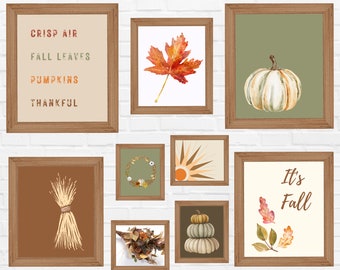 Peut inclure: Onze impressions d'art sur le thème de l'automne, encadrées en bois. Les impressions comprennent des images d'une feuille d'érable, de citrouilles, de blé et du texte qui dit "Crisp Air", "Fall Leaves", "Pumpkins", "Thankful", et "It's Fall".