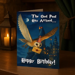 May include: A birthday card with an illustration of an owl in a party hat delivering a letter. The card displays the text "The Owl Post Has Arrived... Happy Birthday!" against a backdrop of a castle and night sky.
