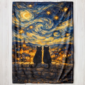 May include: A plush blanket featuring a painting of two black cats silhouetted against a starry night sky. The artwork is reminiscent of Van Gogh's style, with swirling blues, yellows, and oranges. The cats sit on a stone wall overlooking a town.