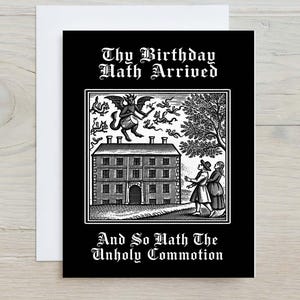 May include: A black greeting card featuring a white woodcut-style illustration of a winged demon playing a drum above a house, with two figures standing below. The text reads: Thy Birthday Hath Arrived and So Hath The Unholy Commotion.