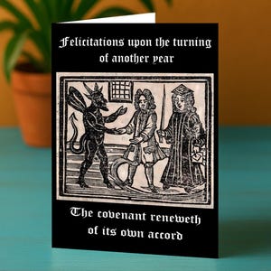 May include: Greeting card with a black background and a vintage illustration. The image features a devil figure shaking hands with two robed figures. The text at the top reads "Felicitations upon the turning of another year" and the text at the bottom reads "The covenant reneweth of its own accord."