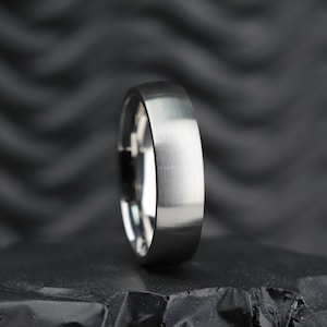 May include: A silver wedding band with a brushed finish.