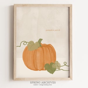 May include: A printable art print featuring a single orange pumpkin with green leaves and vines. The text "pumpkin patch" is written in the top right corner of the print.