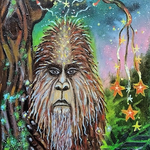 May include: An acrylic painting of a Bigfoot-like creature in a forest setting. The artwork features a detailed face, a full moon, and star-shaped ornaments hanging from a tree branch. The color palette includes greens, browns, and blues.