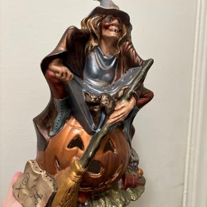 70s Halloween ceramic figurine witch on pumpkin spooky witch decor 10in tall 1970s holiday decor candle book cat broom