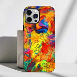 May include: A colourful phone case with a swirling abstract design in shades of yellow, orange, red, blue, and green. The case features a pattern of overlapping circles and a black camera cutout.