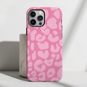 Op de afbeelding: Een roze telefoonhoesje met een luipaardprint. Het hoesje heeft een zwarte rand en een uitsparing voor de camera.
