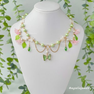 Whimsical Butterfly Necklace, Fairycore Jewelry, Flower Blossom, Green Butterfly, Lily of the Valley, Pink Flowers and Leaves, Cottagecore