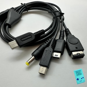 May include: Black multi-connector cable with various plug types, including USB, and other connectors. The cable is coiled and appears to be for electronic devices. The image is on a white background.