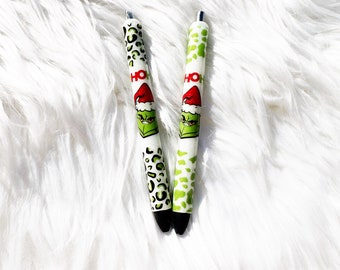 Guepardo navideño, bolígrafos verdes anti-monstruo navideño