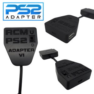 May include: Black PS2 adapter with the text "PS2 ADAPTER" and "RCMU PS2 D ADAPTER VI" printed on it. The adapter has a USB port and a connector cable. The image shows multiple views of the adapter.