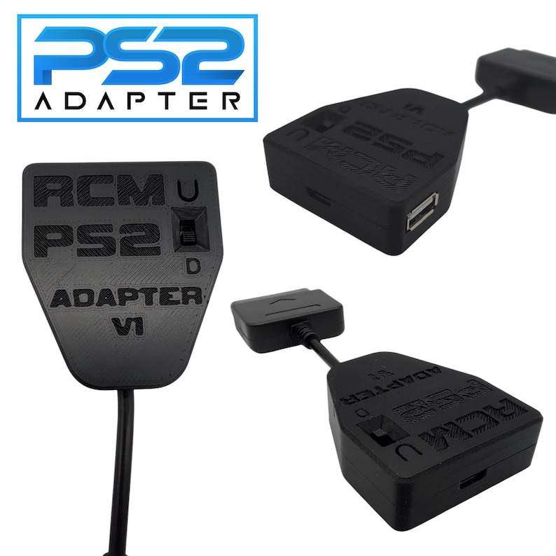 May include: Black PS2 adapter with the text "PS2 ADAPTER" and "RCMU PS2 D ADAPTER VI" printed on it. The adapter has a USB port and a connector cable. The image shows multiple views of the adapter.