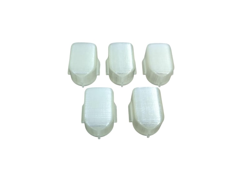 May include: Five white plastic caps for a product, possibly for a bottle or container.