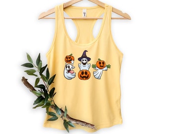 May include: A yellow tank top with a graphic of three ghosts wearing pumpkin heads. The ghosts are holding pumpkins and one is wearing a witch's hat.