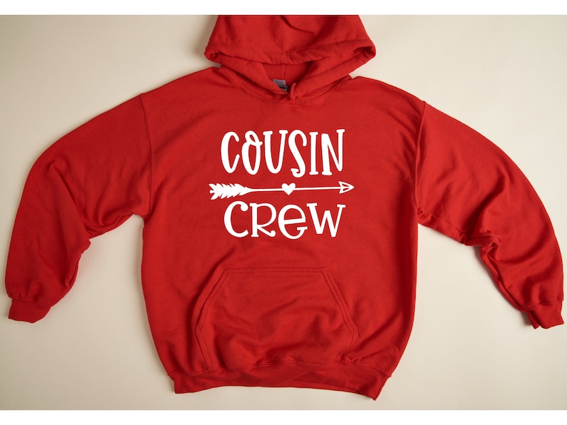 May include: Red hooded sweatshirt with a white graphic that says "COUSIN CREW" with an arrow and a heart.