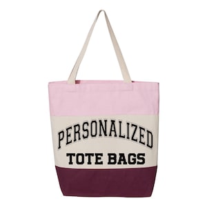 May include: A pink, beige, and burgundy canvas tote bag with the text "PERSONALIZED TOTE BAGS" printed in black.