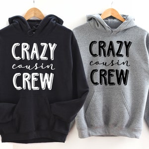 May include: Two hooded sweatshirts with the text "Crazy cousin crew" in white on black and black on grey.