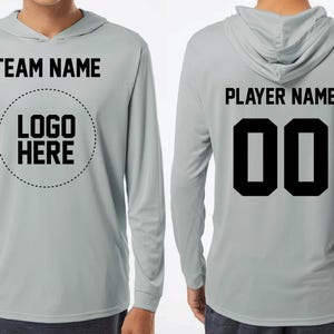 a man wearing a gray hoodie with the name and number on it