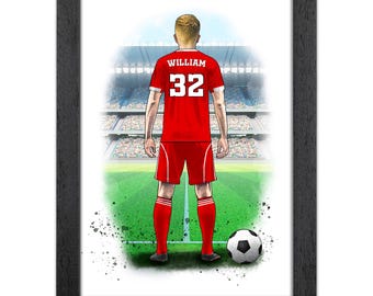 Op de afbeelding: Ingelijste illustratie van een voetballer in een rood tenue met de naam "WILLIAM" en het nummer "32" op de rug. De speler staat op een groen veld met een voetbal, met uitzicht op een stadion vol toeschouwers.