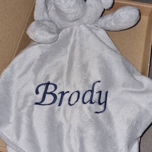 May include: A gray plush elephant security blanket with the name "Brody" embroidered in blue thread.