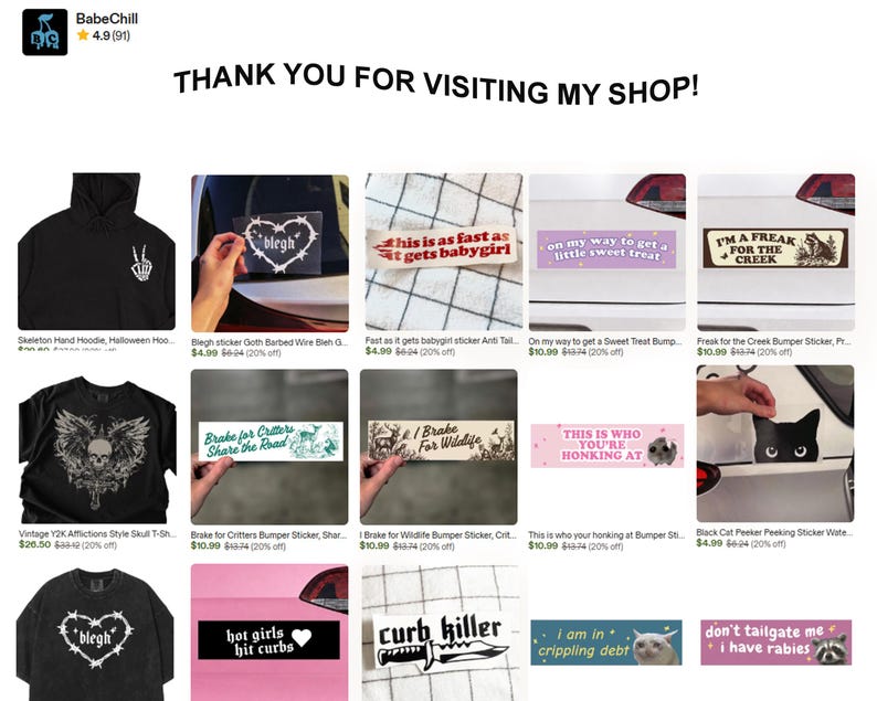 May include: A digital shop storefront display featuring a collection of apparel and bumper stickers. Items include black hoodies and t-shirts with graphic prints, and rectangular bumper stickers with various text slogans and illustrations.