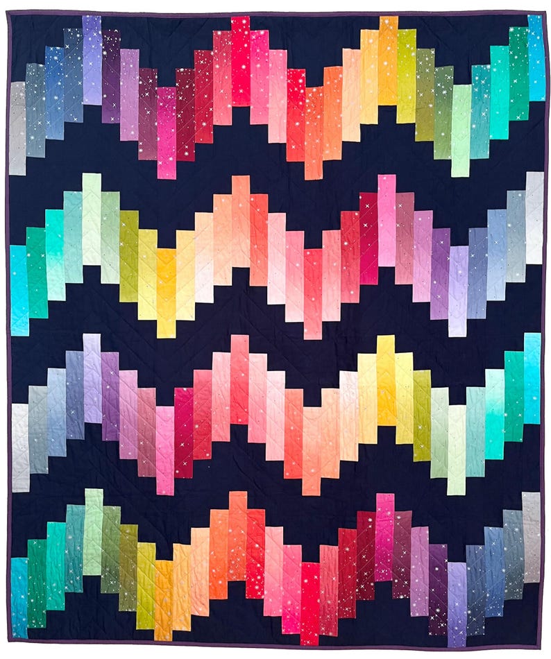 May include: A vibrant quilt with a dark blue backdrop and a zig-zag design in rainbow shades. The quilt showcases a spectrum of colours, such as pink, orange, yellow, green, and blue, forming an eye-catching pattern. This quilt is a comfortable and decorative home textile.